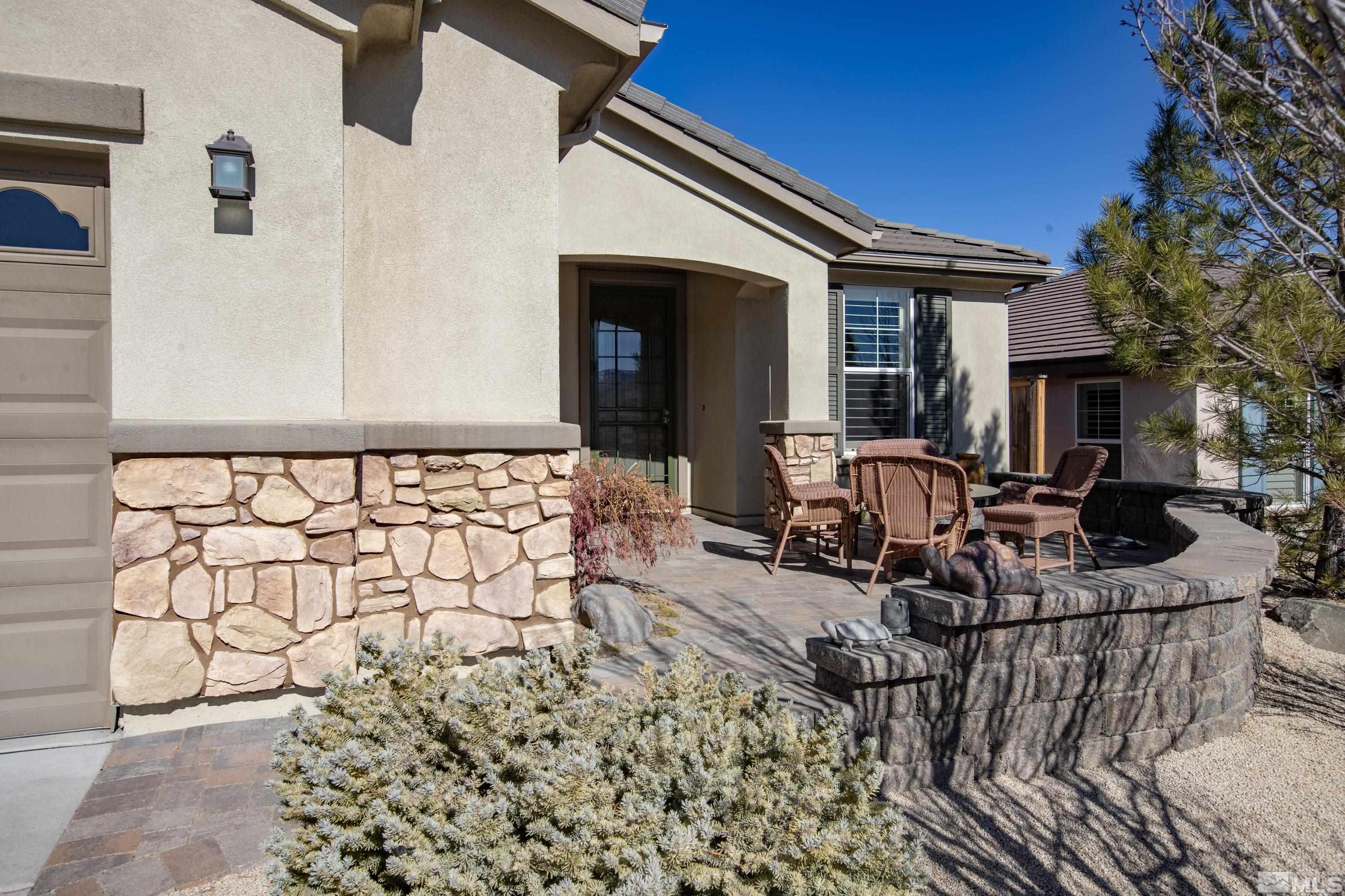 9255 Sassafras Trail Reno, NV 89523 - Photo 2 of 25 a view of a patio with table and chairs and potted plants