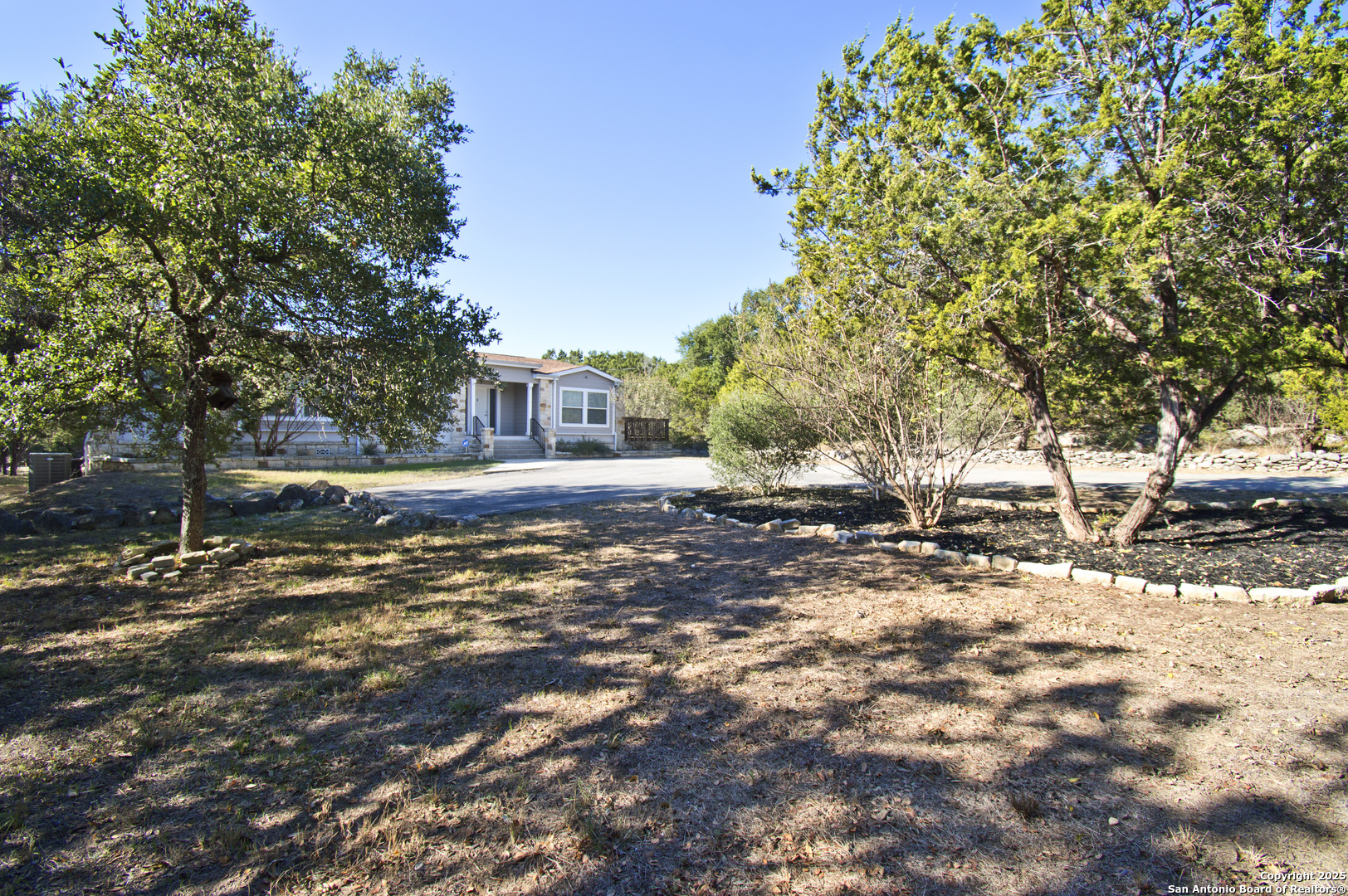 108 Fawn Drive Spring Branch, TX 78070 - Photo 3 of 31 a view of a large yard with plants and trees
