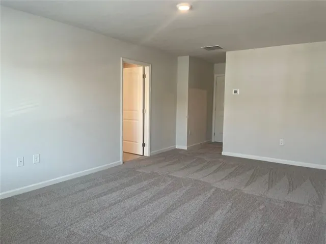 an empty room with closet and a window