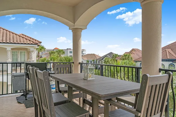 a view of a balcony with furniture and a floor to ceiling window