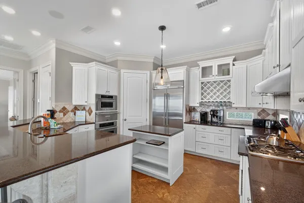 a kitchen with stainless steel appliances a sink a stove and a refrigerator