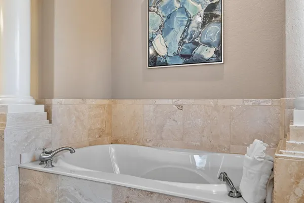 a bedroom with a bed and a flat tv screen on dresser