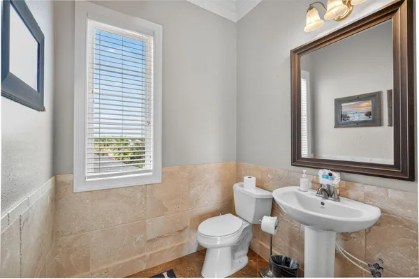 a bathroom with a granite countertop sink a mirror and a shower