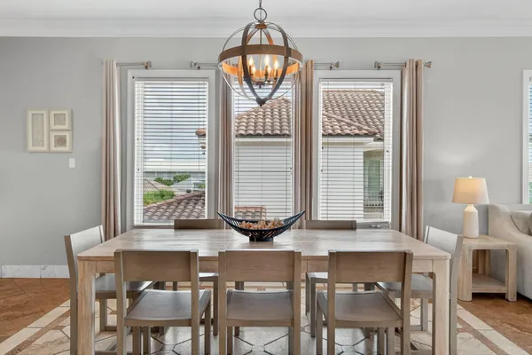 a view of a dining room with furniture and a window