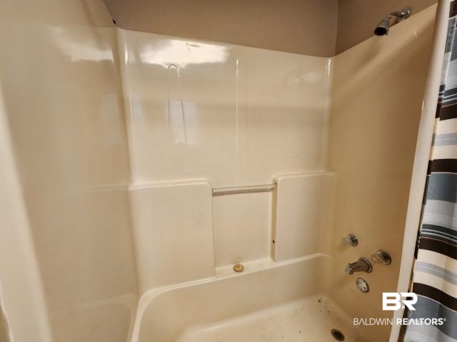 32749 Antietam Road Lillian, AL 36549 - Photo 30 of 47 Bathroom featuring shower / bath combo with shower curtain