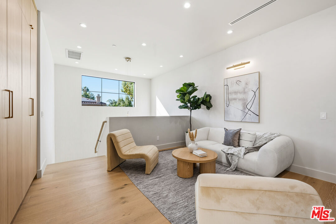 16643 Addison Street Encino, CA 91436 - Photo 14 of 31 a living room with furniture and painting on the wall