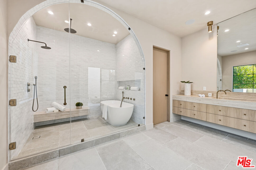 16643 Addison Street Encino, CA 91436 - Photo 17 of 31 a bathroom with a double vanity sink mirror and shower