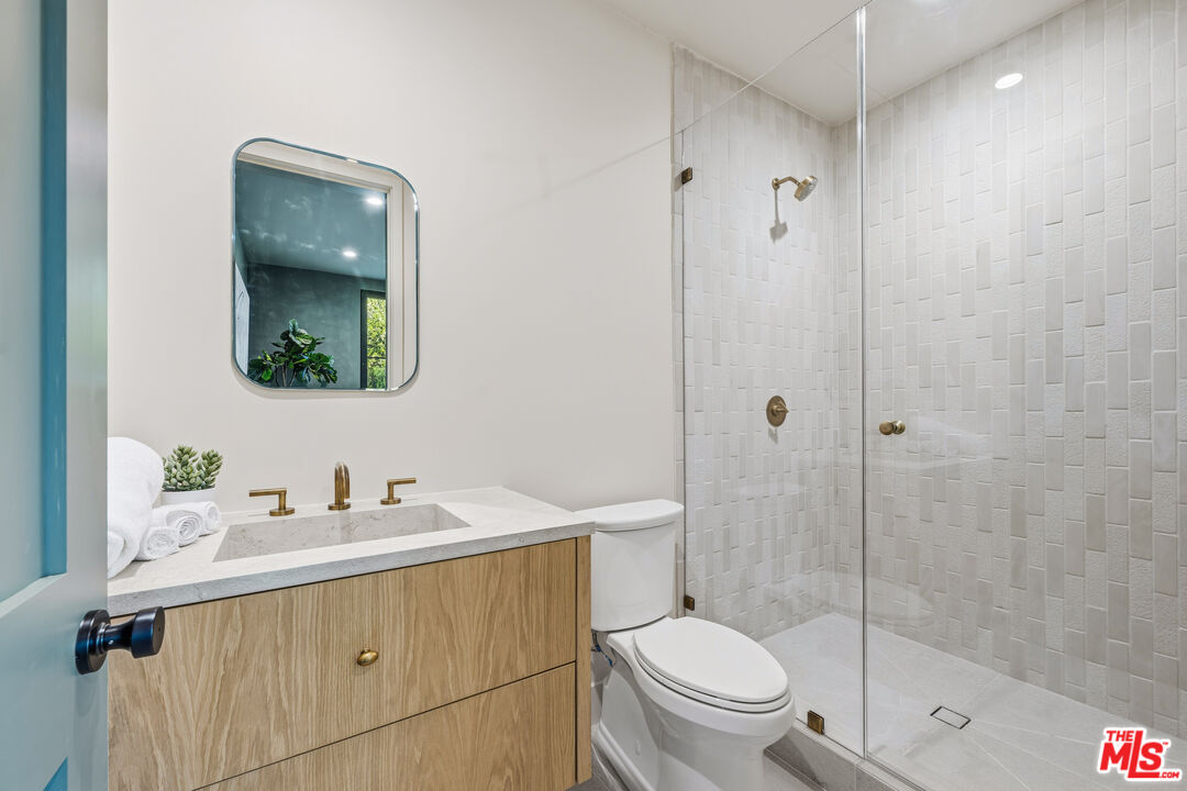 16643 Addison Street Encino, CA 91436 - Photo 29 of 31 a bathroom with a sink a toilet and shower