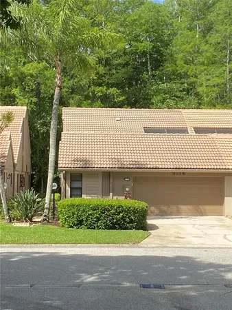 a view of a house with a yard and floor to ceiling window