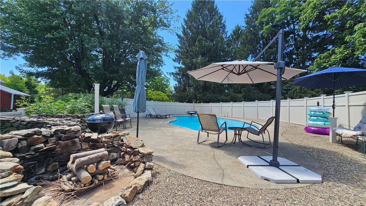 585 Buttermilk Road Hellertown, PA 18055 - Photo 44 of 82 An inviting backyard oasis offers a sparkling pool with ample space for relaxation.