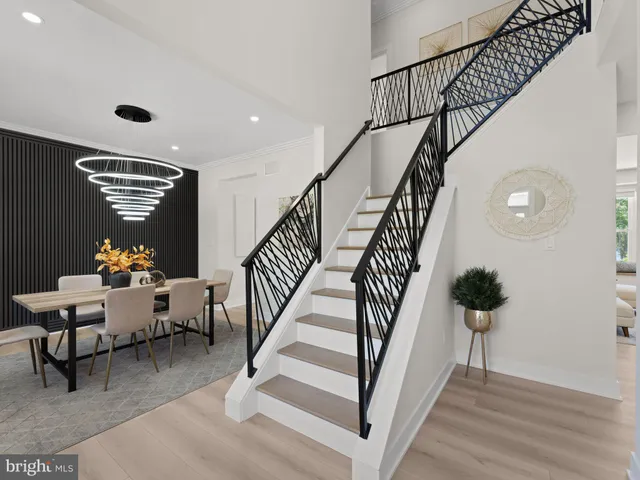 a large kitchen with stainless steel appliances kitchen island granite countertop a refrigerator and a stove top oven