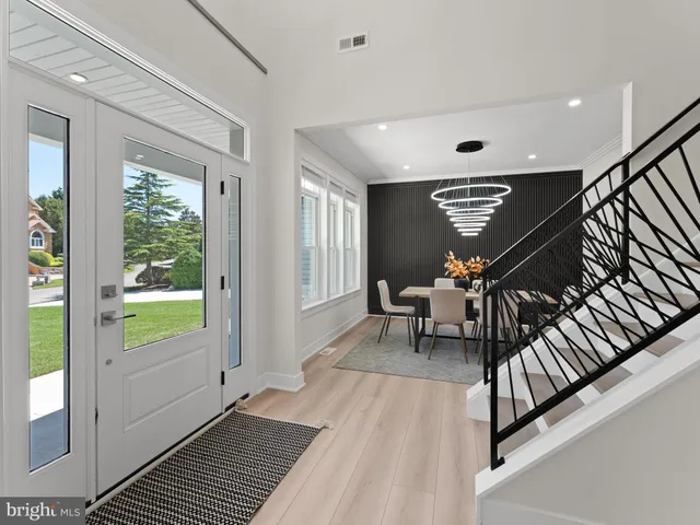 a large white kitchen with a large counter top appliances and cabinets