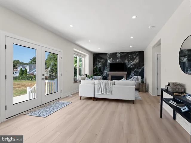 a living room with a couch and a potted plant