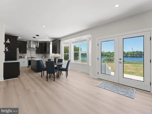 a bedroom with a large bed and wooden floor