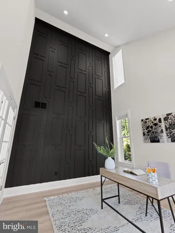 a view of a hallway with wooden floor and stairs