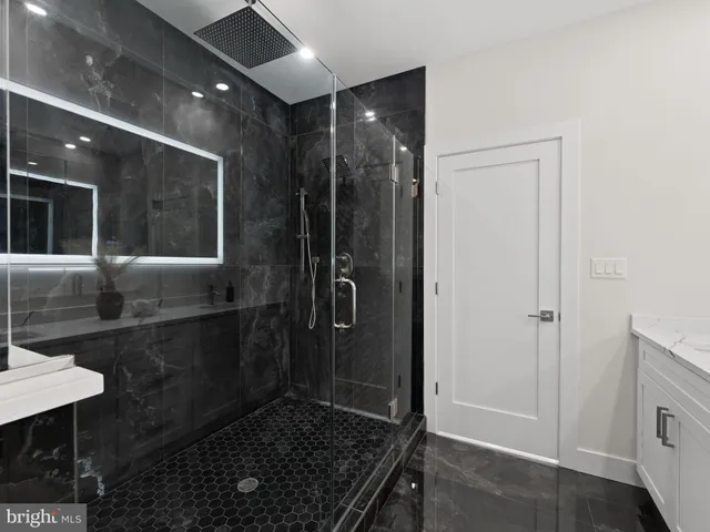 a view of a room with a sink and wooden floor
