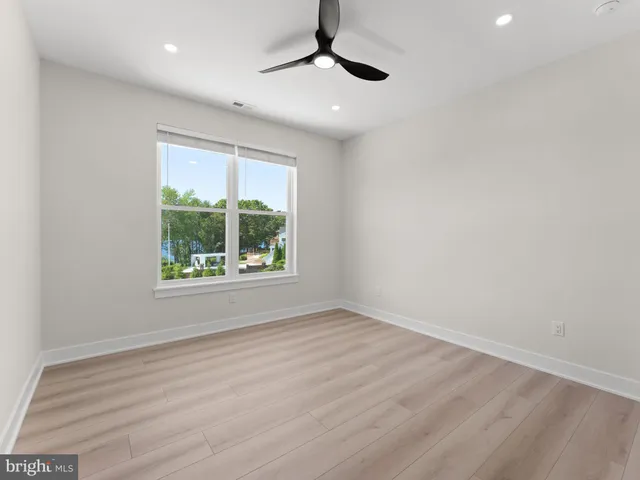 an aerial view of residential houses with outdoor space and lake view