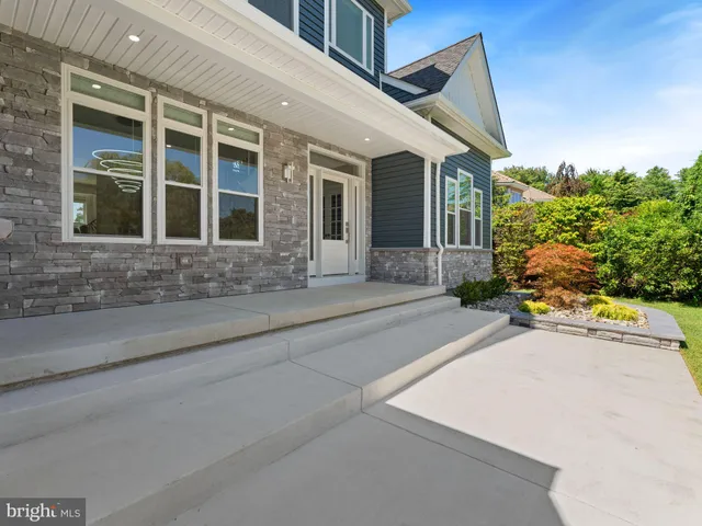 a dining room with furniture a chandelier and wooden floor
