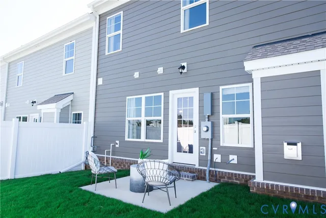 a view of a house with a backyard and a patio