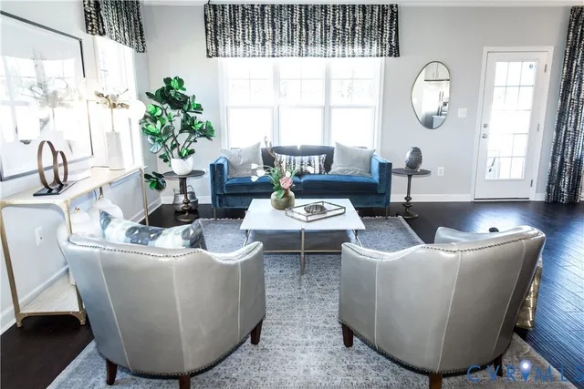 a living room with furniture a window and a potted plant
