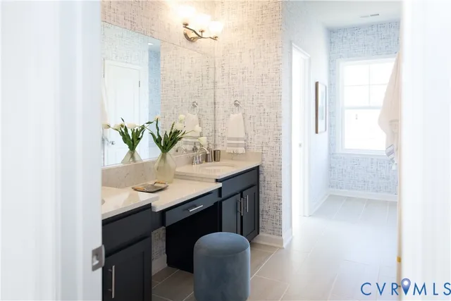 a bathroom with a granite countertop sink a mirror and a