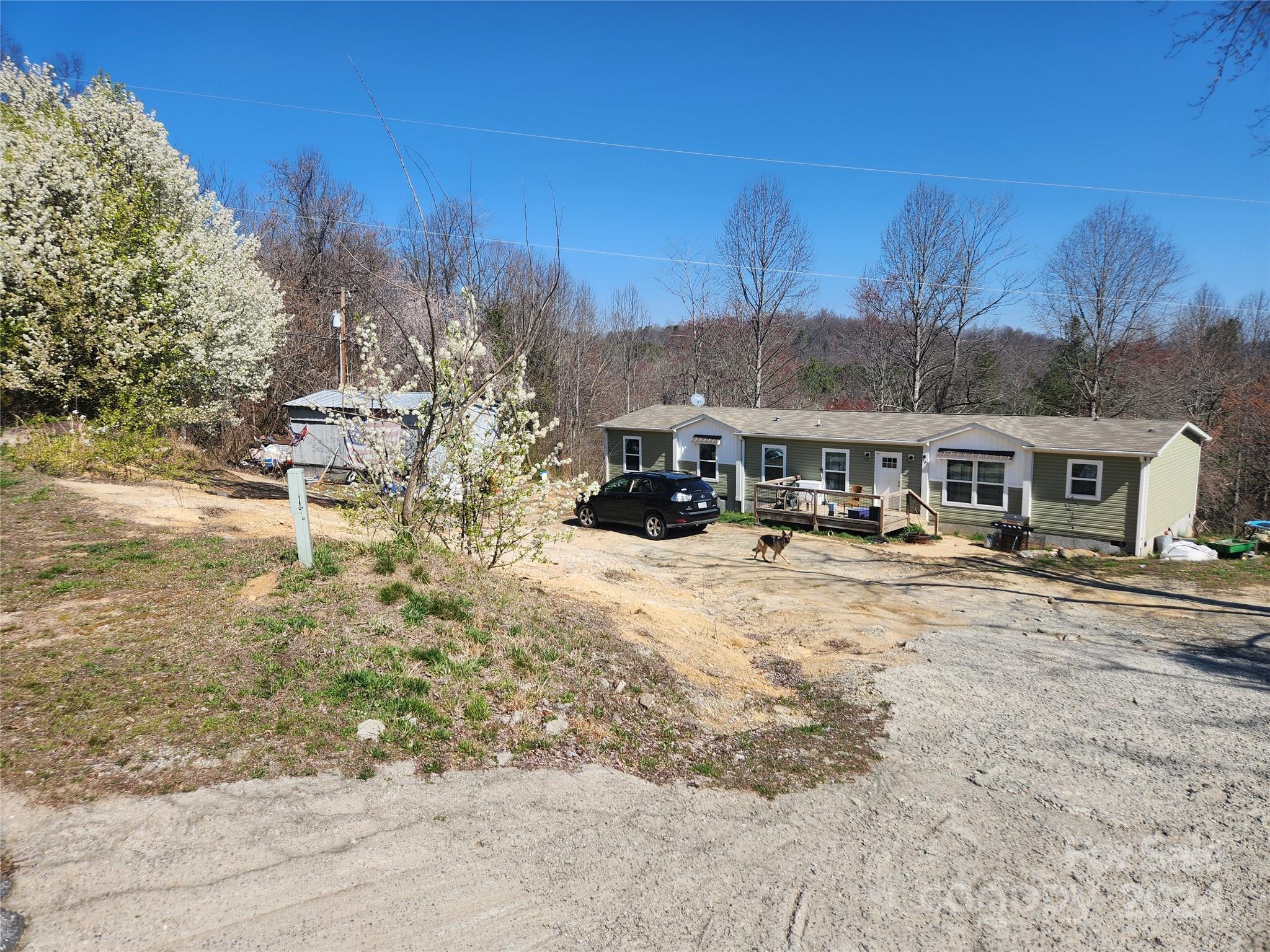 305 Deep Gap Loop Road Flat Rock, NC 28731 - Photo 1 of 7 a front view of a house with a yard covered with snow and trees in the background