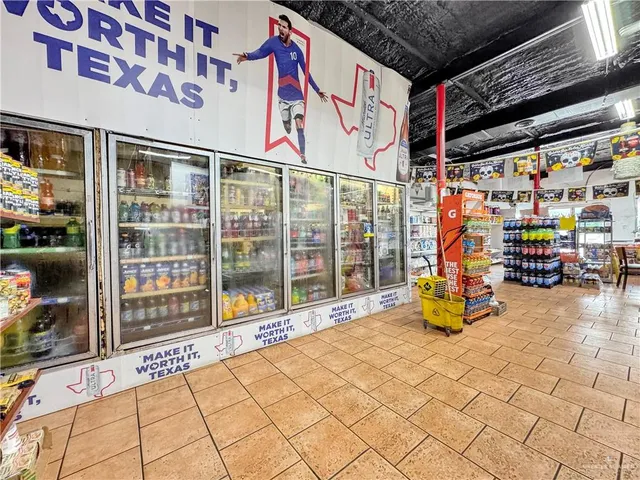 a hallway with lots of wooden furniture and stainless steel appliances