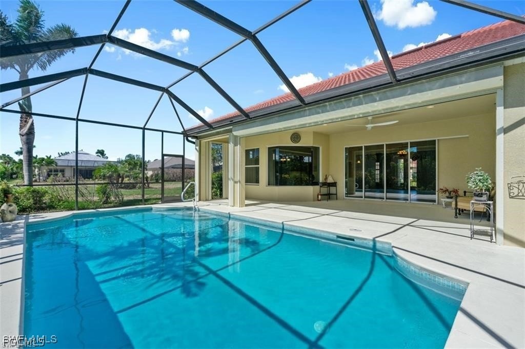 16113 Coco Hammock Way Fort Myers, FL 33908 - Photo 1 of 16 a view of a house with a swimming pool