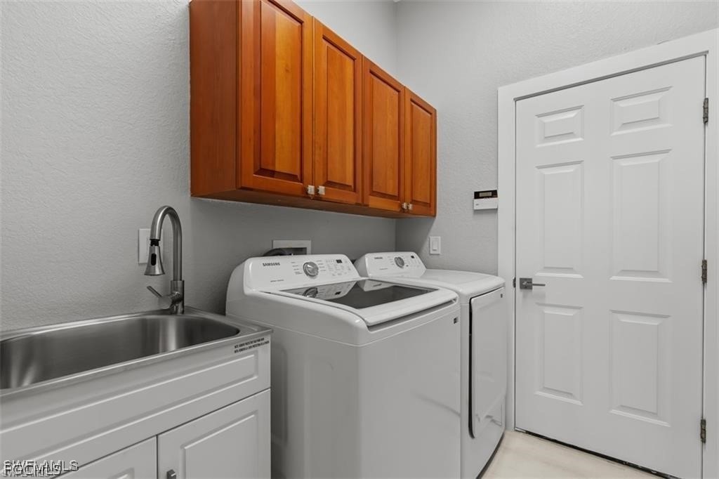 16113 Coco Hammock Way Fort Myers, FL 33908 - Photo 13 of 16 a utility room with dryer and washer