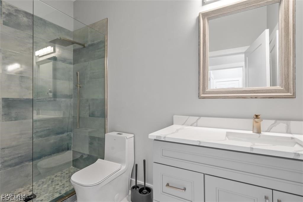 16113 Coco Hammock Way Fort Myers, FL 33908 - Photo 16 of 16 a bathroom with a sink a toilet and shower