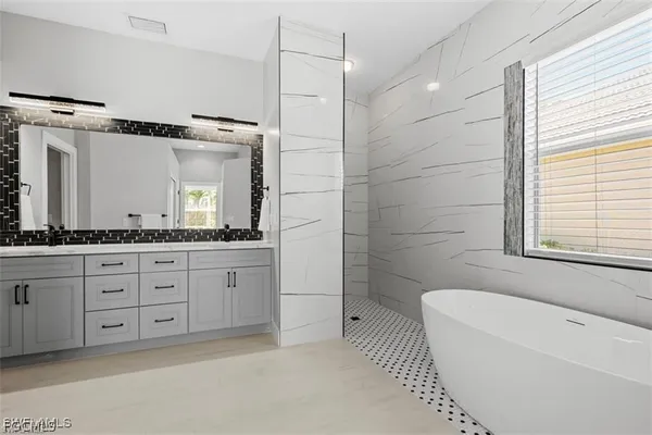 a bathroom with a granite countertop sink a toilet a mirror and shower