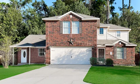 a front view of a house with a garden and yard