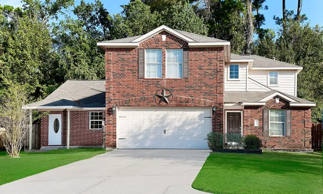 a front view of a house with a garden and yard