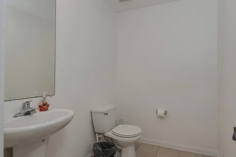 a bathroom with a sink mirror and toilet