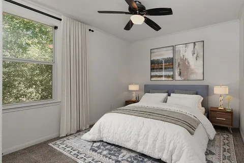 a bedroom with a large bed and a window