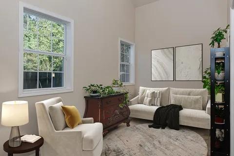 a living room with furniture and a large window