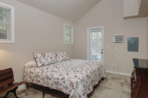 a bedroom with a bed and a chair