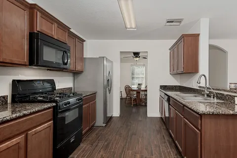 a kitchen with stainless steel appliances a stove cabinets and a sink