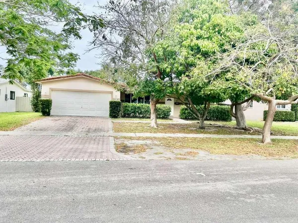 a view of a house with a large tree and a big yard