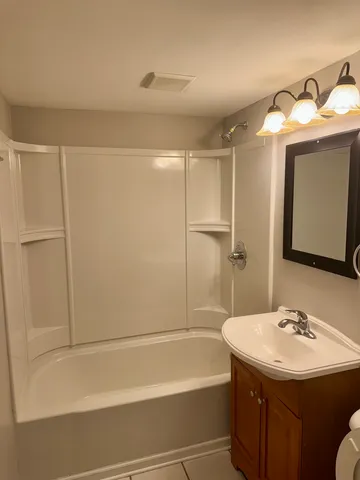a bathroom with a sink toilet and mirror