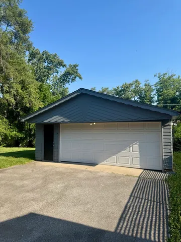 a view of a field of grass and trees