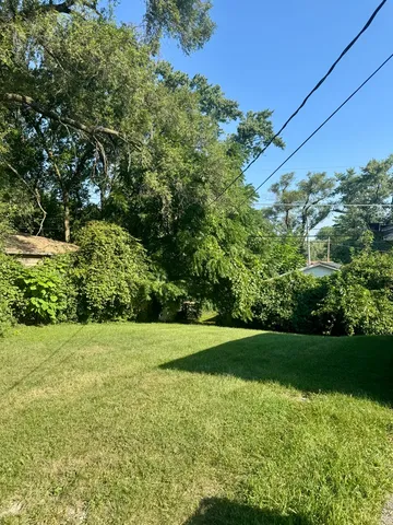 a view of a back yard of the house with green space