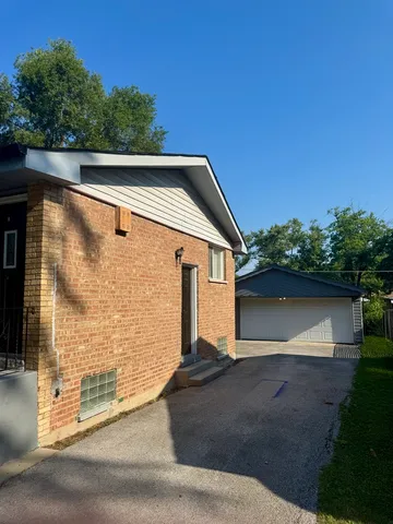 a backyard of a house with yard fire pit and outdoor seating