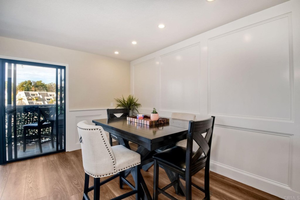 4705 Marina Drive, Unit 5 Carlsbad, CA 92008 - Photo 11 of 30 a view of a dining room with furniture window and wooden floor