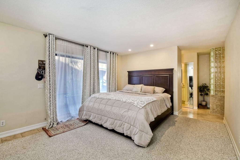 4705 Marina Drive, Unit 5 Carlsbad, CA 92008 - Photo 15 of 30 a spacious bedroom with a bed and a mirror