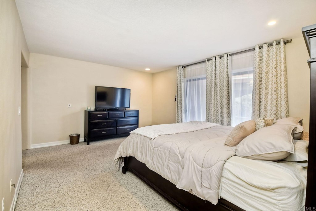 4705 Marina Drive, Unit 5 Carlsbad, CA 92008 - Photo 16 of 30 a bedroom with a bed and a television