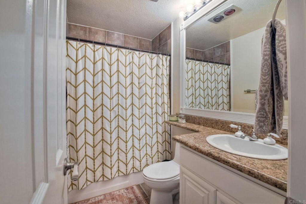 4705 Marina Drive, Unit 5 Carlsbad, CA 92008 - Photo 19 of 30 a bathroom with a granite countertop sink and a mirror