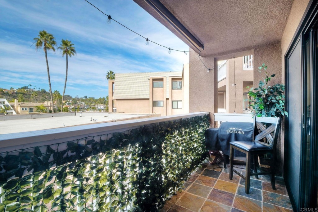 4705 Marina Drive, Unit 5 Carlsbad, CA 92008 - Photo 20 of 30 a living room filled with furniture and a potted plant