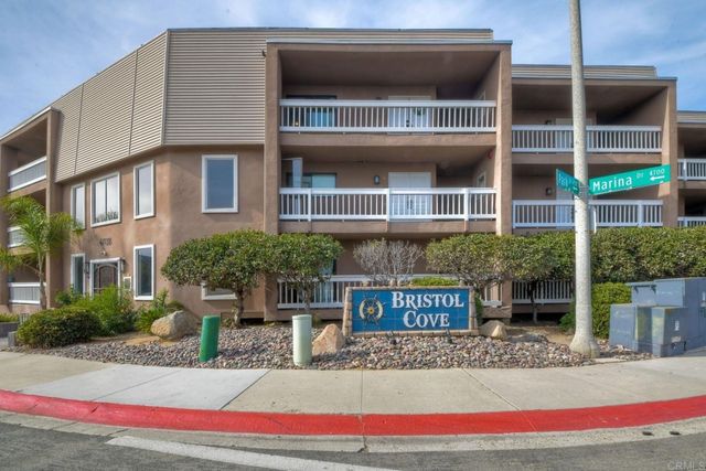 a building outdoor space with patio furniture and potted plants