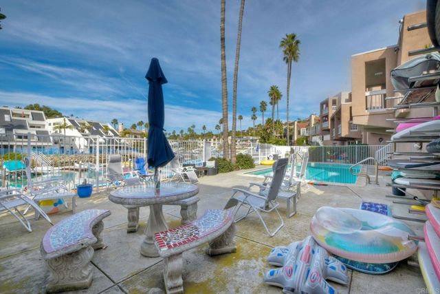 a balcony with table and chairs